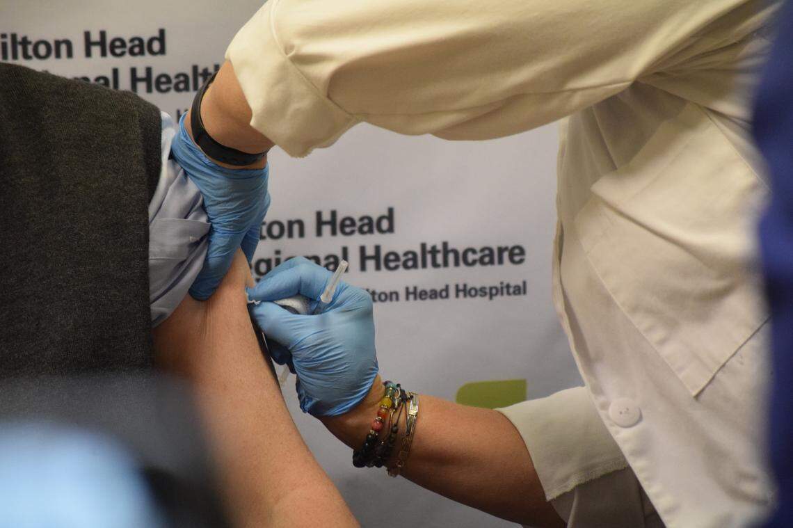 A nurse at Hilton Head Hospital prepares to inject Dr. James Gigante, an internist, with a dose of the Pfizer-BioNTech coronavirus vaccine on Wednesday, Dec. 16, 2020 on Hilton Head Island.