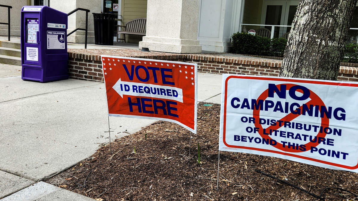 Signs direct voters to bring identification to vote as well as alerting those that campaigning or the distribution of campaign literature is not allowed in May 2026 at the Bluffton Branch of the Beaufort County Library system.