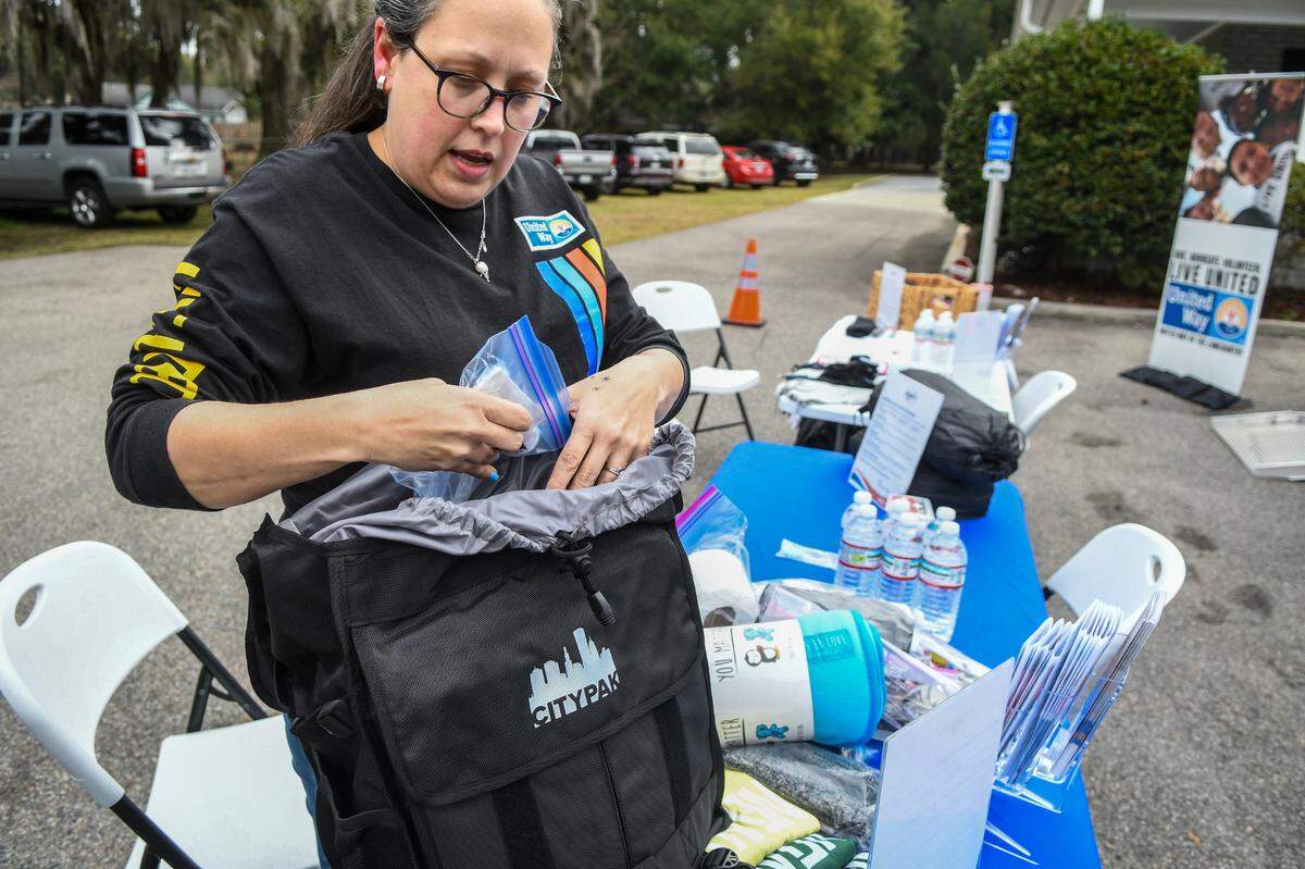 Angela Boswell, community impact manager for the United Way of the Lowcountry, goes through the more than 100 items that are included in the Citypak backpacks at the United Way headquarters on Feb. 20, 2025, in Beaufort that they’ll distribute to the homeless in Beaufort and Jasper counties.