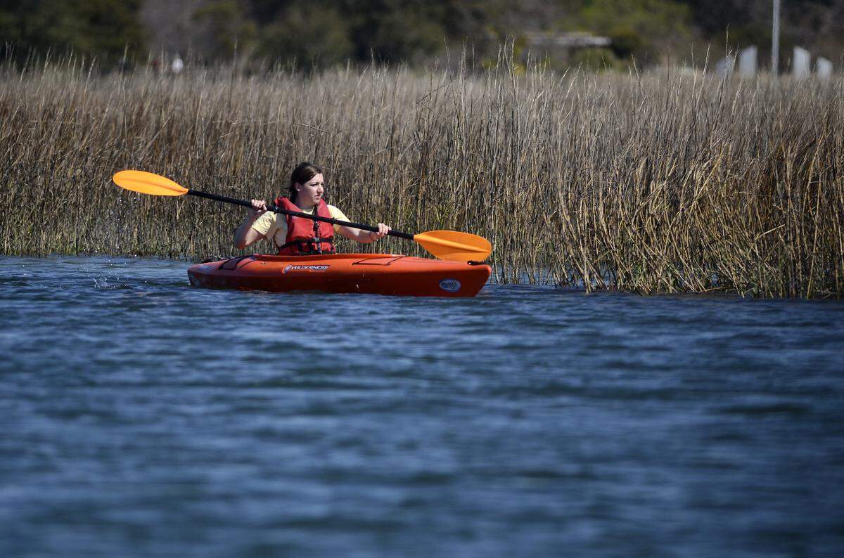 A kayaker participating in the Outside Hilton Head Green Team Broad Creek Clean-up by kayak looks for trash on an afternoon in 2014.