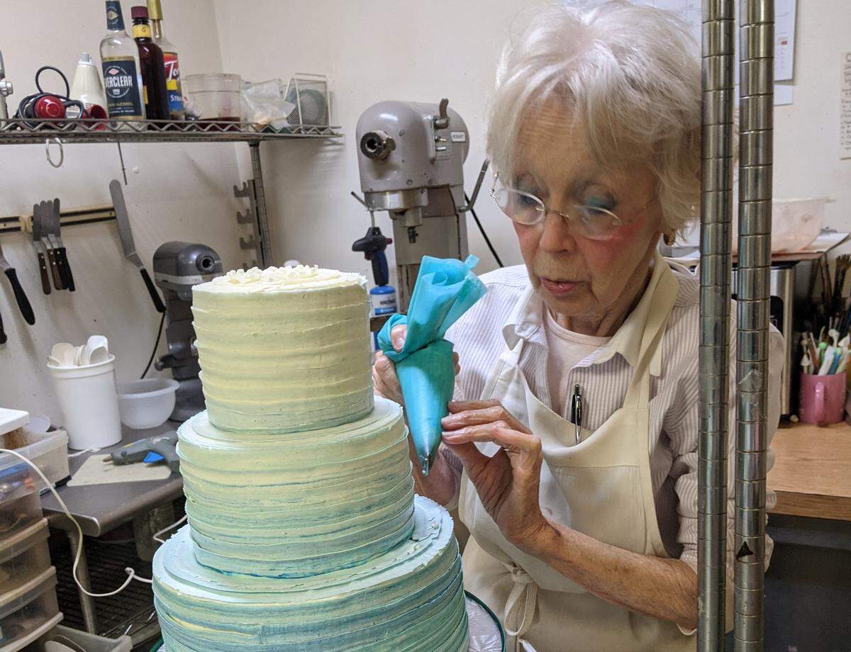 Signe Gardo decorates a tiered cake. She estimates she’s had a hand in more than 4,000 wedding cakes over her 50-plus years in business on Hilton Head Island.