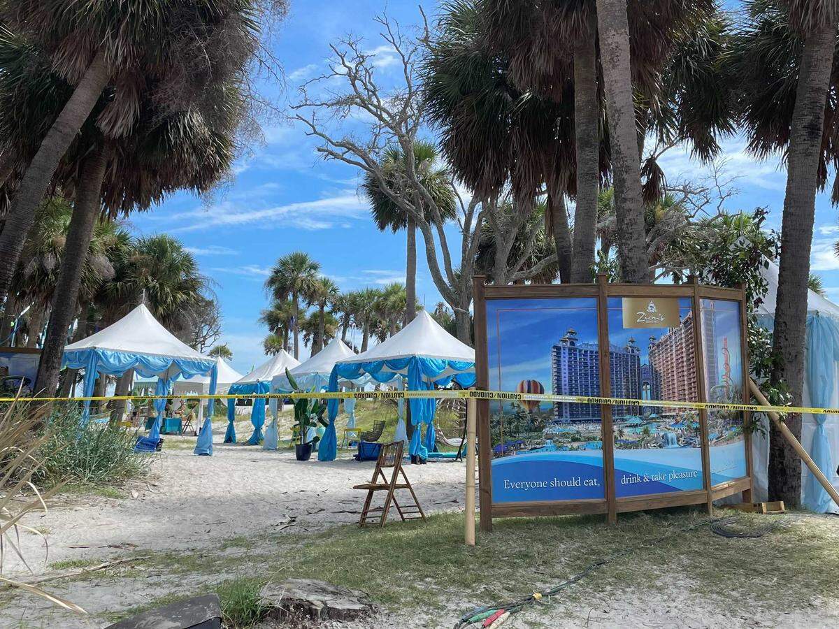 Ecclesiastes 3:13, “Everyone should eat drink & take pleasure in all his toil,” can be seen at the bottom of a banner on the set of HBO’s “The Righteous Gemstones” on Hunting Island on Saturday, Aug. 14, 2021.