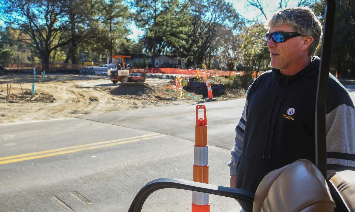 Hilton Head Island resident Daniel Anthony stands along Jonesville Road near a recently patched road on Friday, Jan. 6, 2023 with some of the property under development visible to the left. Anthony said the construction team dug up the entire road at once which shut down access to his neighborhood for several hours.