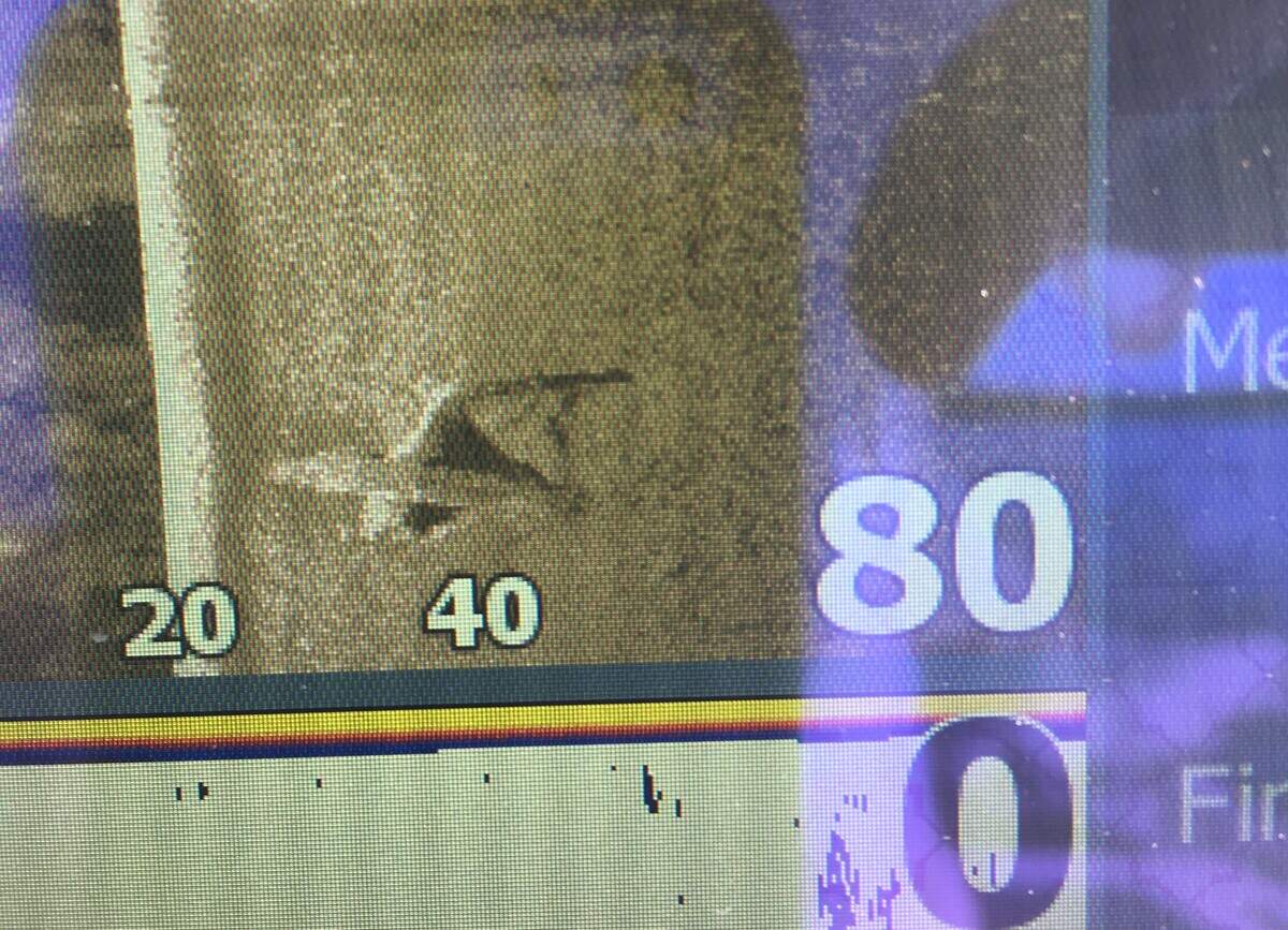 A photograph of the sonar display shows the shape of the plane on the bottom of the May River.