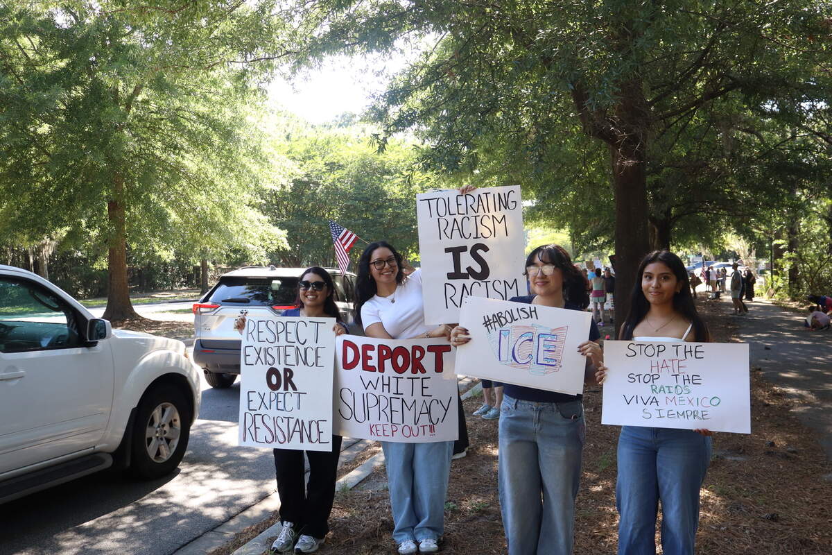 A group of protesters pose with their signs outside the Myrtle Park Government Center in Bluffton on June 5, 2026.