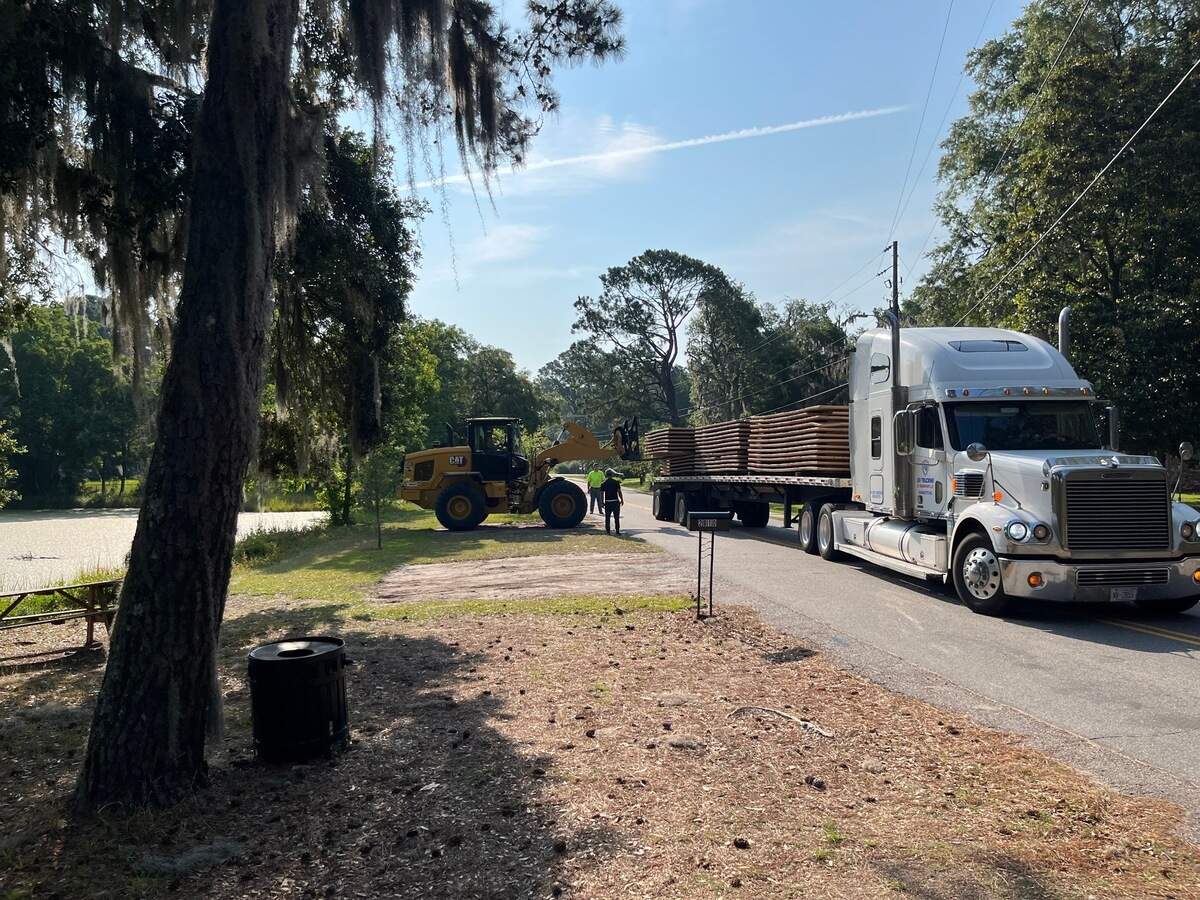 Mats, delivered to the Duck Pond Wednesday, will be used to protect the ground from heavy equipment during dredging of a ditch between the pond and Battery Creek, which is clogged with debris.