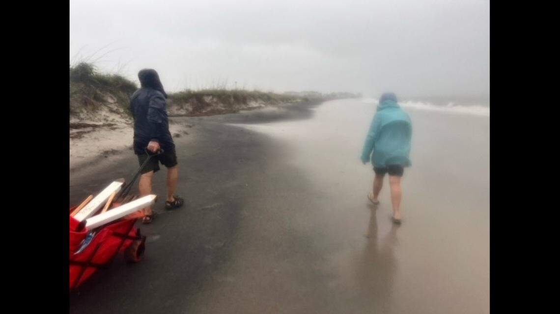 Volunteers walk the beach at Harbor Island during Tropical Storm Debby on their way to checking nests of loggerhead sea turtles.
