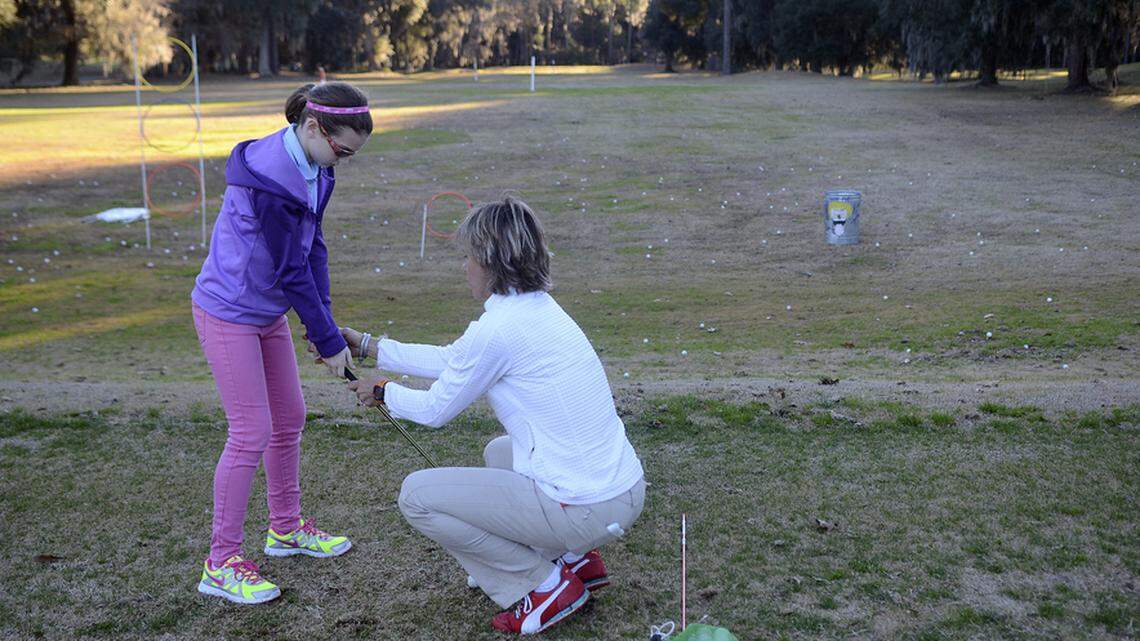 FILE: Krista Dunton, right, site director with LPGA Girls Golf Club of Bluffton, helps Kierstin Clark, 12, of Hilton Head Island with her grip during the club's free open house Jan. 12, 2014, at Rose Hill Golf Club in Bluffton.