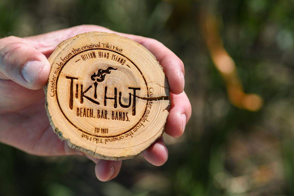 Jay Wiendl, general manager of Beach House Hilton Head Island holds a coaster-sized drink holder on May 30, 2024 that was made from the former Tiki Hut roof.