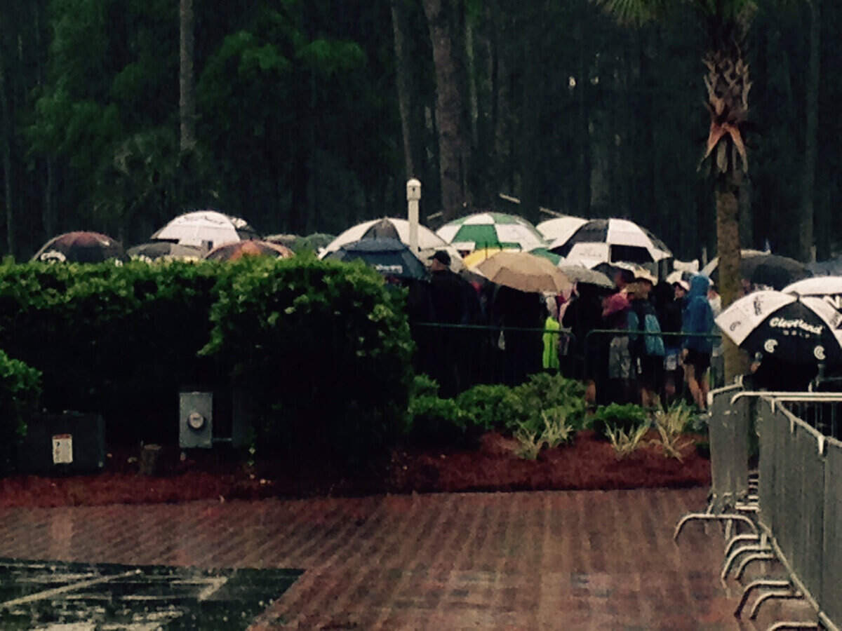 Umbrellas cover spectators in the early stages of the rainy final round of the 2015 RBC Heritage Presented by Boeing.