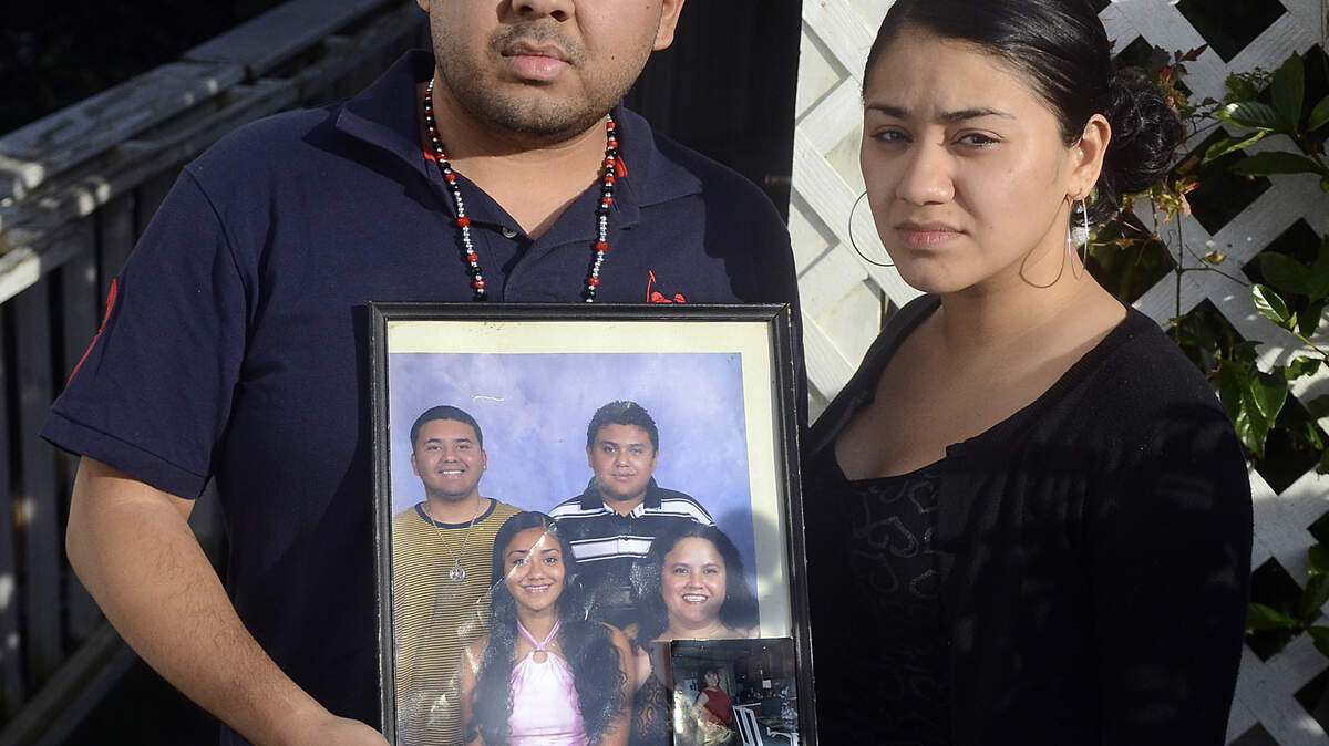 Jonathan Manrique and his sister Dayra Manrique, both of Bluffton, hold a family photograph while standing in front of their mother's home Dec. 12, 2013, in Bluffton.  Their mother, Margarita Gonzalez-Almazan, 47, of Bluffton has been missing since Dec. 1.  She was last seen with her boyfriend, Osman Galicia-Escobedo, at a family party that she hosted at the Shady Glen community center.