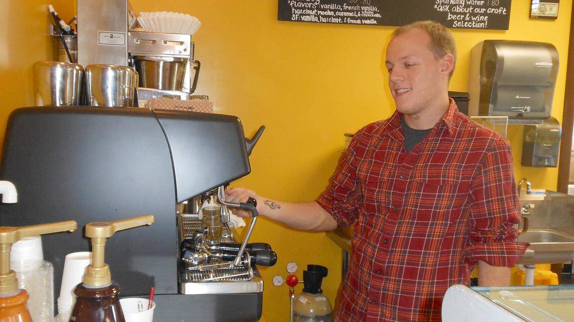 General manager and barista Cory Bennett is hard at work making fresh coffee for customers. 