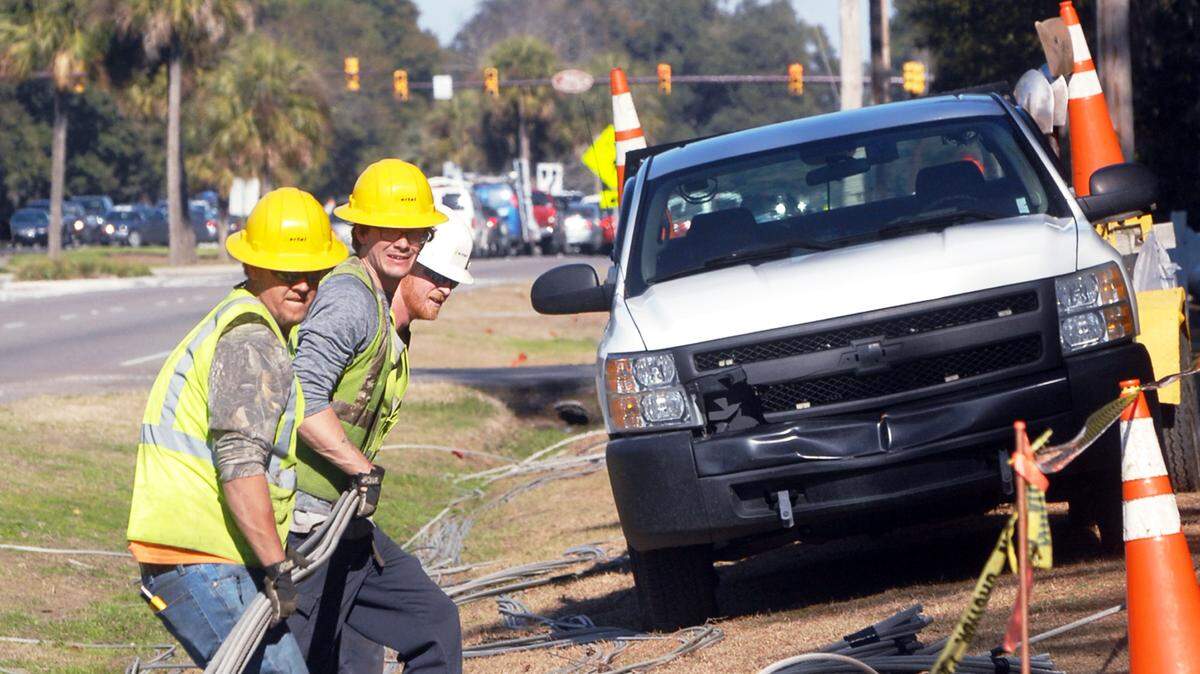 Workers from Ertel Construction remove power lines Feb. 12, 2015. The work along the shoulder of William Hilton Parkway across from the Hilton Head Diner is part of an ongoing project to replace Hilton Head's overhead power lines with buried cables. The 15-year Overhead to Underground Power Line Conversion Project, now in its ninth year, is paid for through a franchise fee paid by Palmetto Electric.