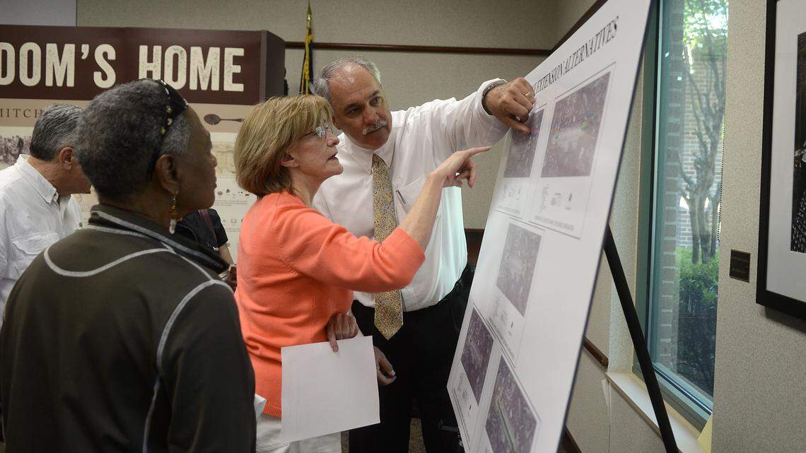 Pat Turney, an engineer with Talbert, Bright & Ellington Inc., explains the diagrams for the runway extension alternatives to Marie Hartis of Hilton Head Island at the public hearing about the environmental impact of extending the runway of Hilton Head Airport the evening of April 21, 2014, at the Hilton Head Island Library on Hilton Head Island.