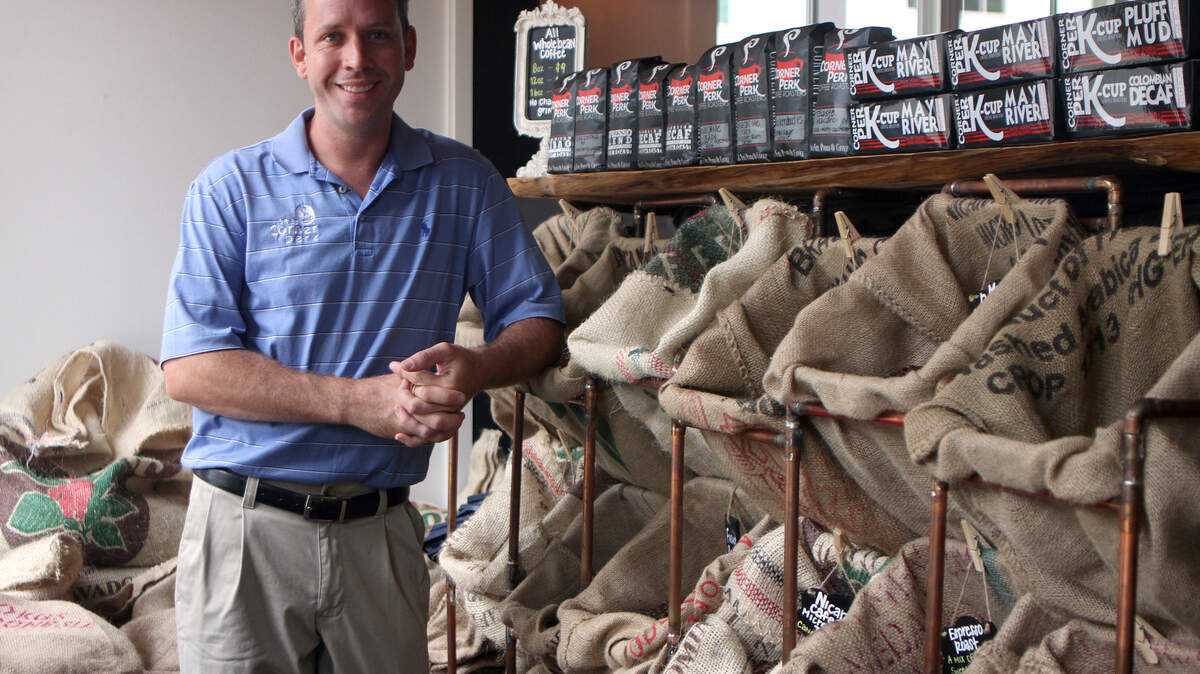 Josh Cooke, owner of Corner Perk in Bluffton, smiles for a portrait in the entrance of the shop on Tuesday afternoon.