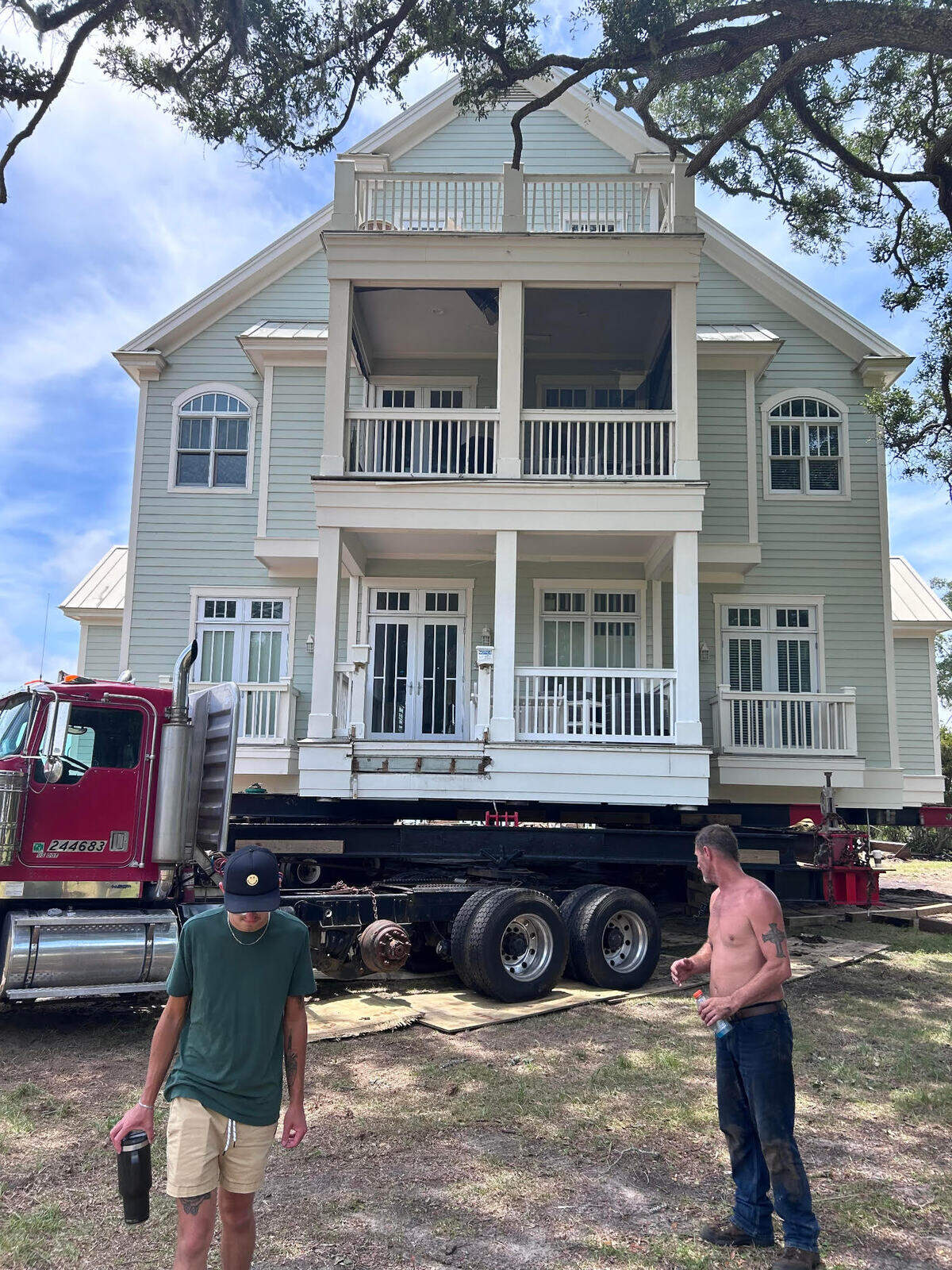 There is plywood underneath the red truck to disperse the weight of the home. The plywood accounts for the creaking sounds while the trucks pull the home.