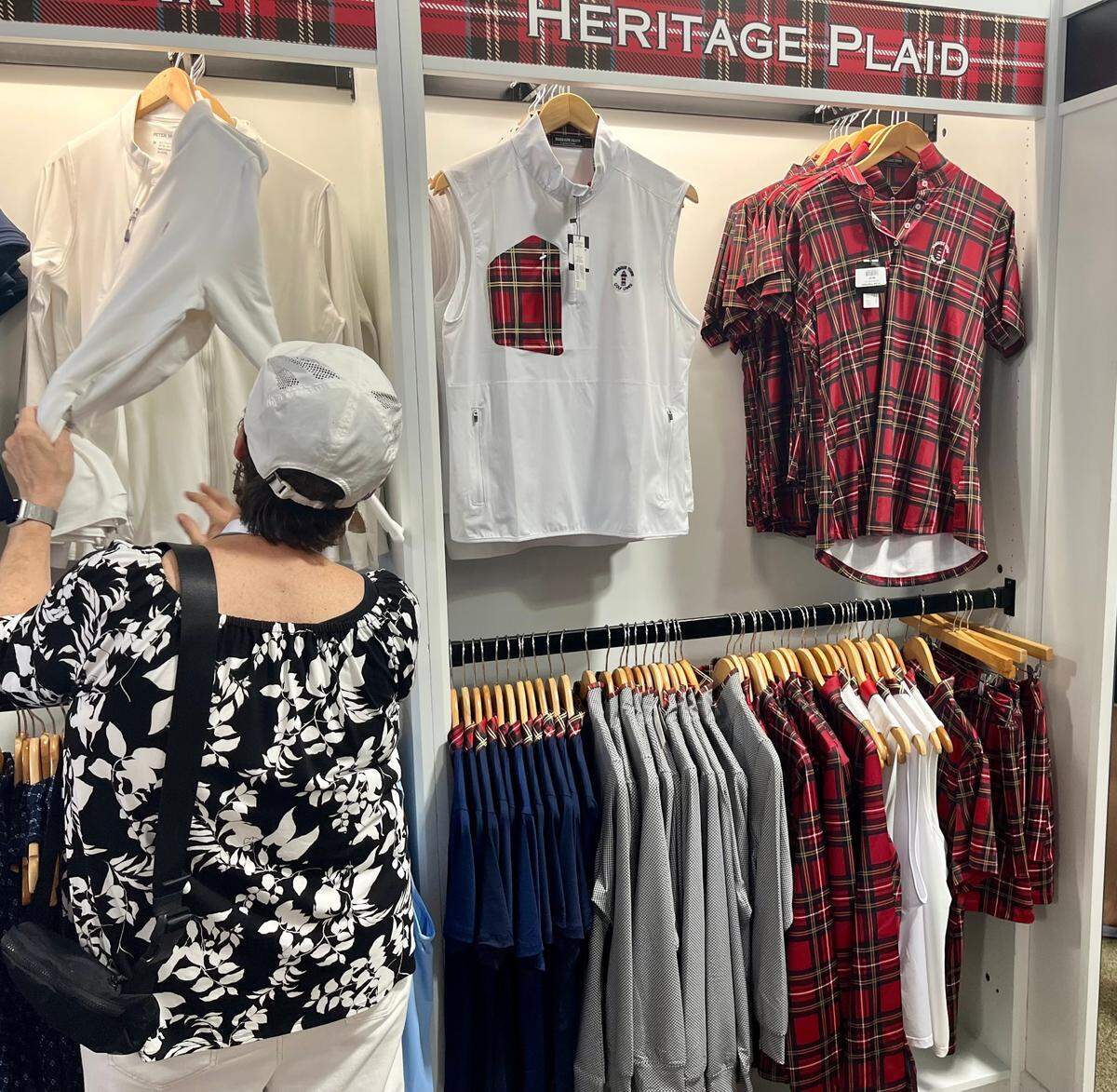 Women’s clothing items like golf tops and tartan plaid skirts for purchase inside the RBC Heritage Golf Shop, Friday, April 18 2025