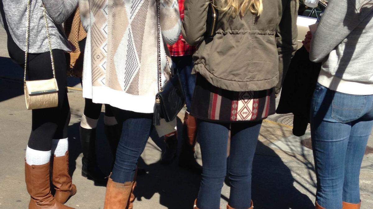 A group of brown boot fans waits outside a restaurant in Savannah.