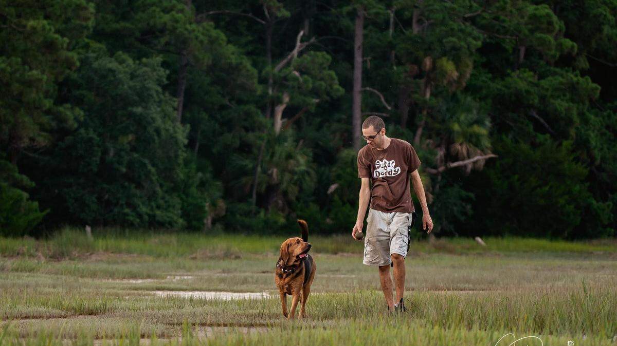 Todd Rackliff walks with his 2 1/2-year-old service bloodhound Butterbean. Rackliff is diabetic and Butterean alerts him when his blood sugar is low.