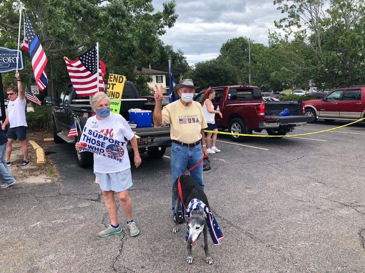 A man at the “Back the Blue” rally holds up a peace sign.