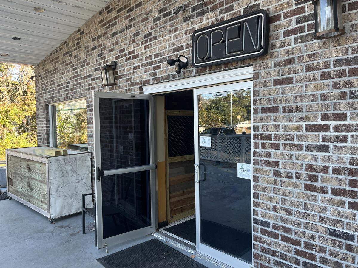 Previously hung on the outside patio, a yellow sign with black handprints reading “Willie’s Bar and Grill” was on the floor and resting against a table the morning of Nov. 19, 2025, after Willie Turral removed it from the building he leases. Turral, who has operated the restaurant since 2023, decided to close the business after Beaufort County Sheriff P.J. Tanner sought to revoke his business and liquor licenses in the wake of a mass shooting at the bar the morning of Oct. 12, 2025.