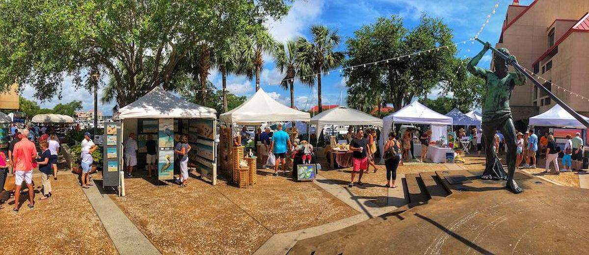 Attendees walk around and look at art displayed at the annual HHI Art Festival at Shelter Cove.