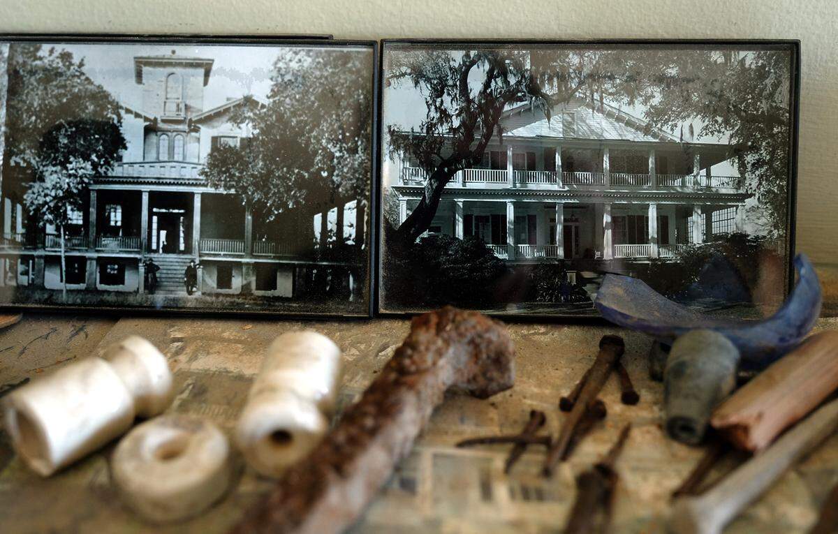The mantel in the living room of Tidalholm as seen on Thursday morning showcases some of the old materials that were found in the house as it's being restored. Two historic photographs show the home with a four-window cupola or belvedere on the top of the original home, left, and after, right, a roof addition was added covering the aforementioned structure.