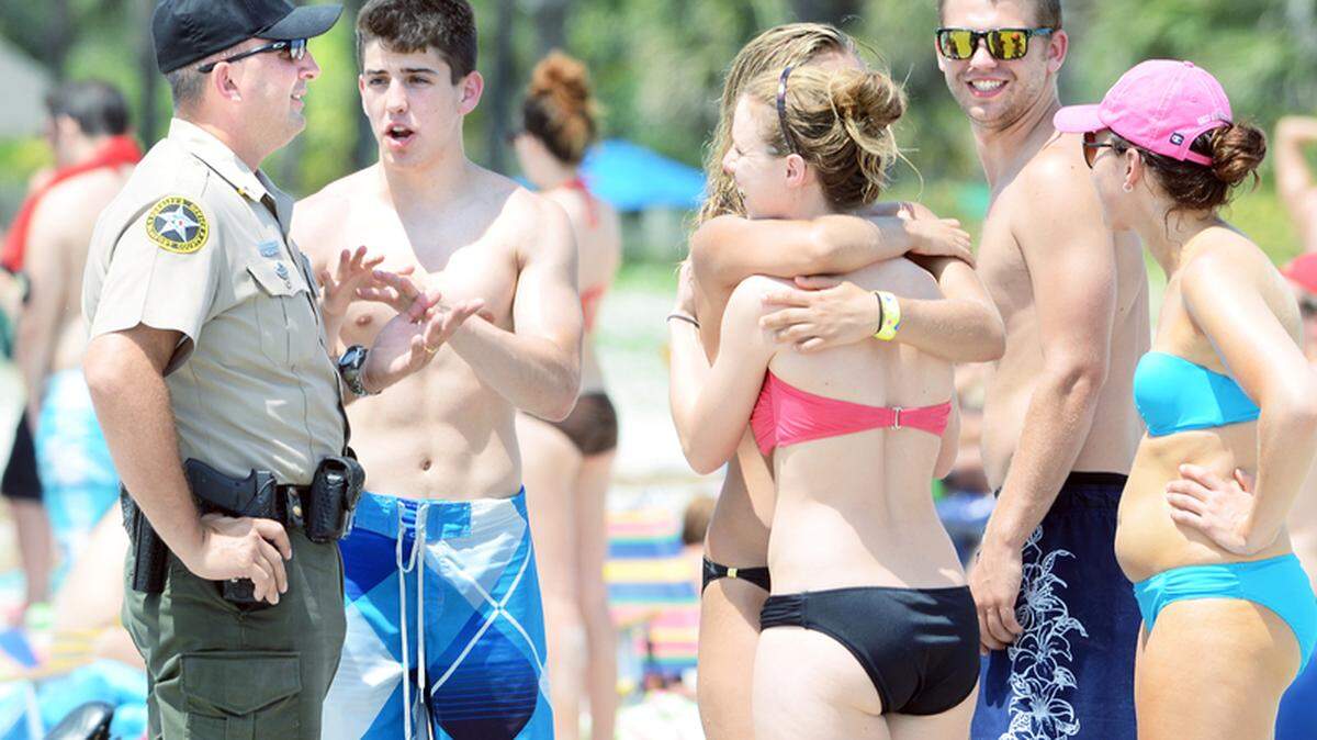 A sheriff's deputy talks to some young beachgoers on Friday afternoon while patrolling the very busy Coligny Beach area on Hilton Head Island. The Beaufort County Sheriff's Office says it is prepared for the invasion of Ohio University and other college students to Hilton Head on their annual Memorial Day weekend beach trek. Town Council member Kim Likins says Forest Beach owners have been complaining to her about the noise and mess the students cause. The Sheriff's Office plans to step up what is calls "proactive patrols," where it tries to keep kids out of trouble with warnings.