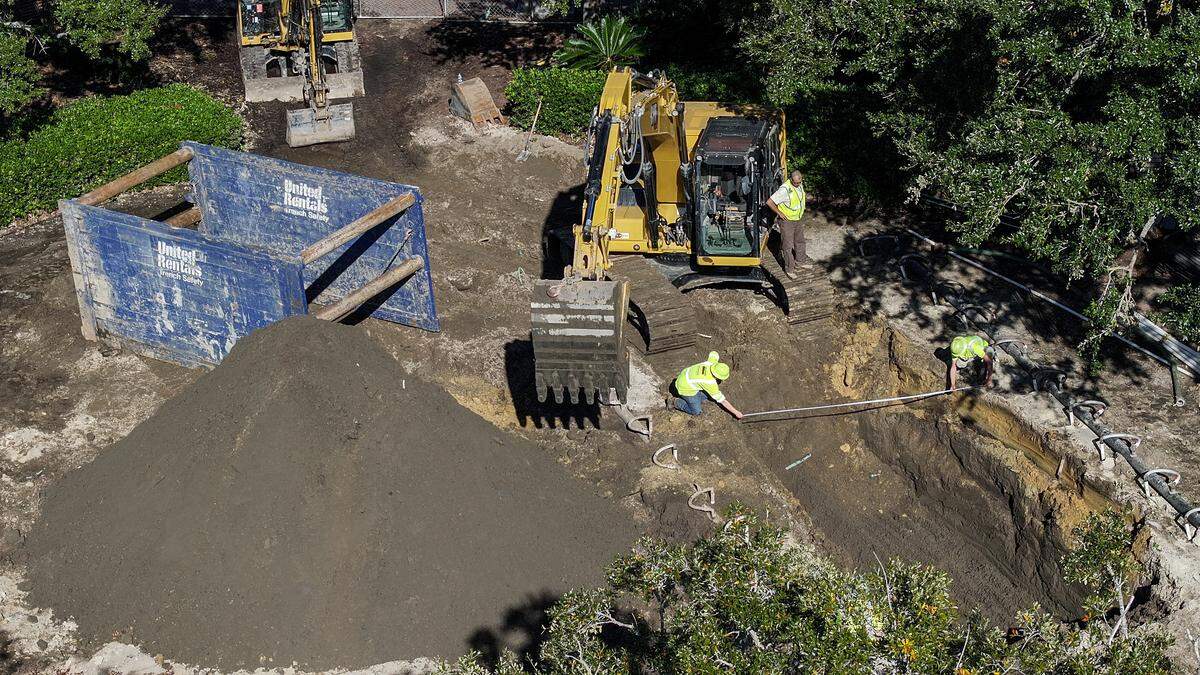 Workers measure the width of their dig to see if the hole will accommodate a trench shield, left, for the $9.7 million storm water improvement project at the location of the outfall. Photographed on Nov. 18, 2025, at Henry C. Chambers Waterfront Park in downtown Beaufort.