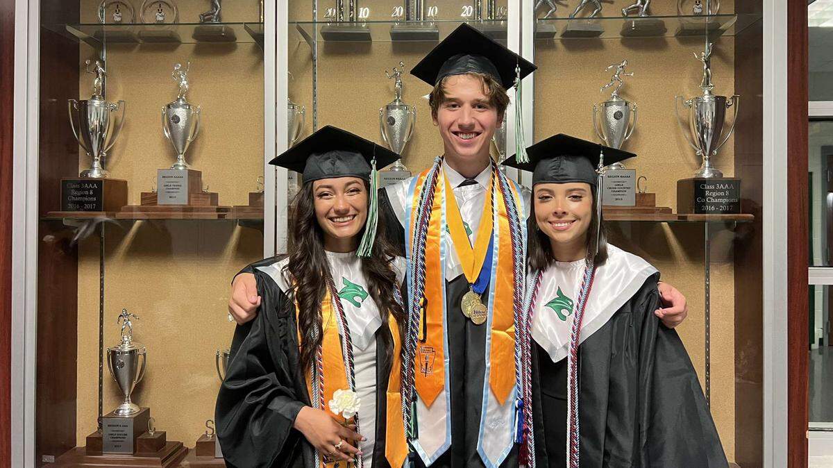 August Rios surrounded with good friends Nathalie Mejia-Esquivel (left) and Adriana Campos (right) at Bluffton High School graduation.