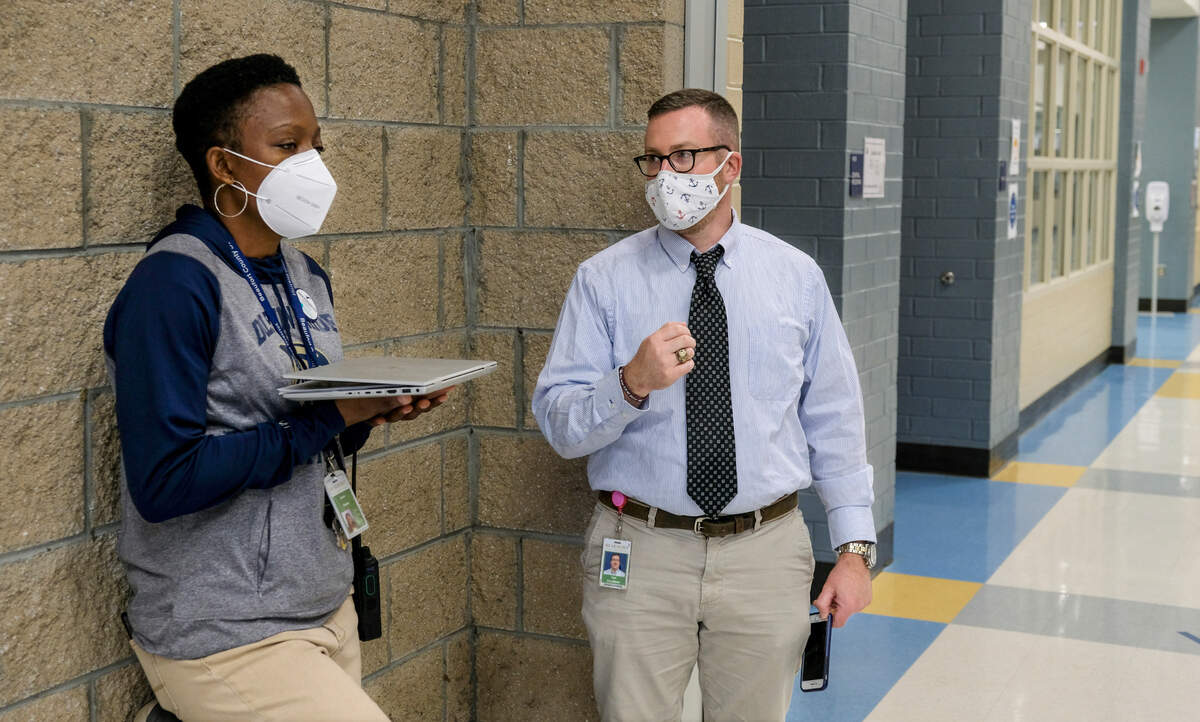 Battery Creek High School teachers Sarah Hayes, left, and Ryan Copeland wait to speak to a reporter outside the gymnasium on Thursday, March 11, 2021 after receiving their first shot of the Pfizer COVID-19 vaccine earlier in the day. Beaufort Memorial Hospital would be at the high school for roughly 5-hours to vaccinate all employees in the Beaufort County School District, not just teachers.