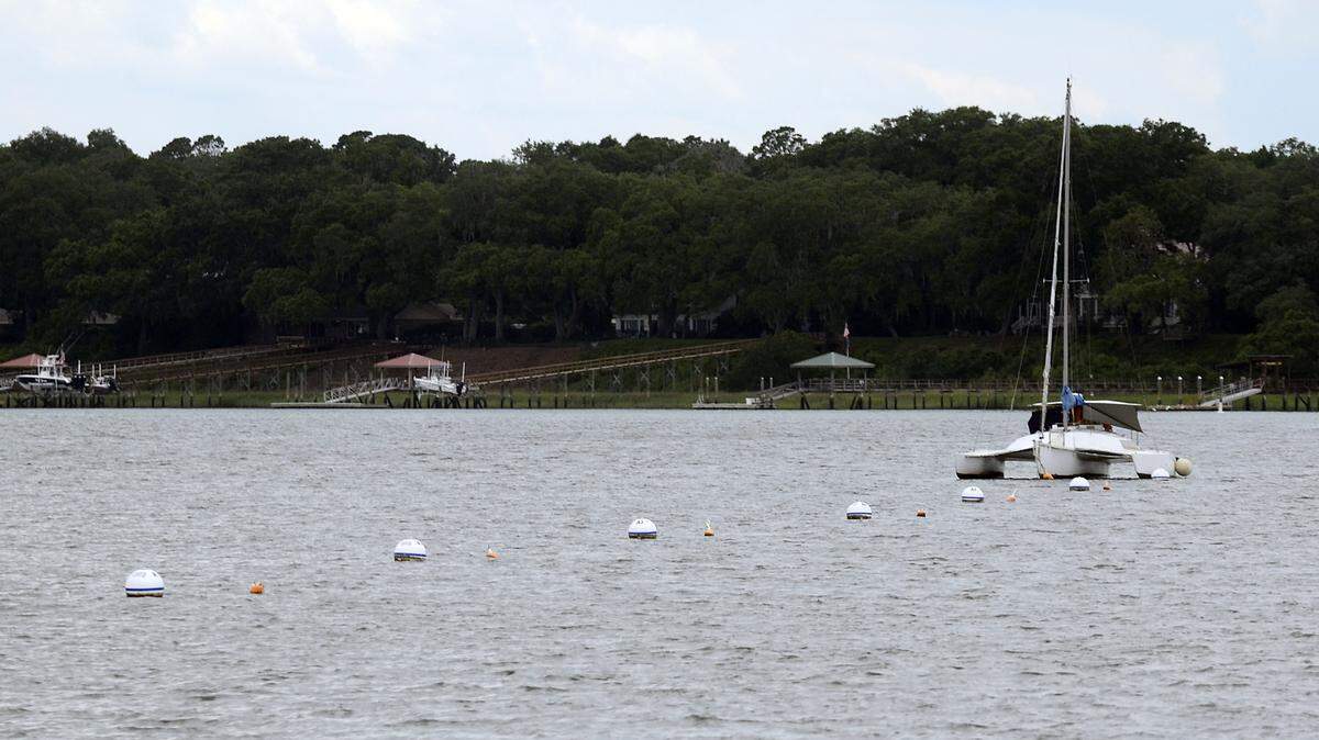 A sailboat sits moored in the mooring field next to the Downtown Marina on Friday night in Beaufort.