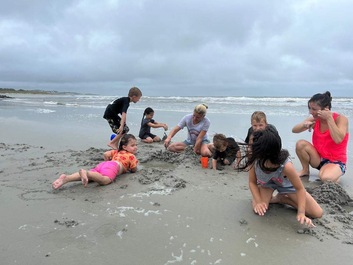 Ali (left) and Nikki Gesk were on vacation and spent the morning on a Hilton Head Island, South Carolina, beach on Tuesday, Aug. 6, 2024. The storm isn’t preventing the kids, who are cousins, from playing in the sand. “They don’t even notice,” Nikki said