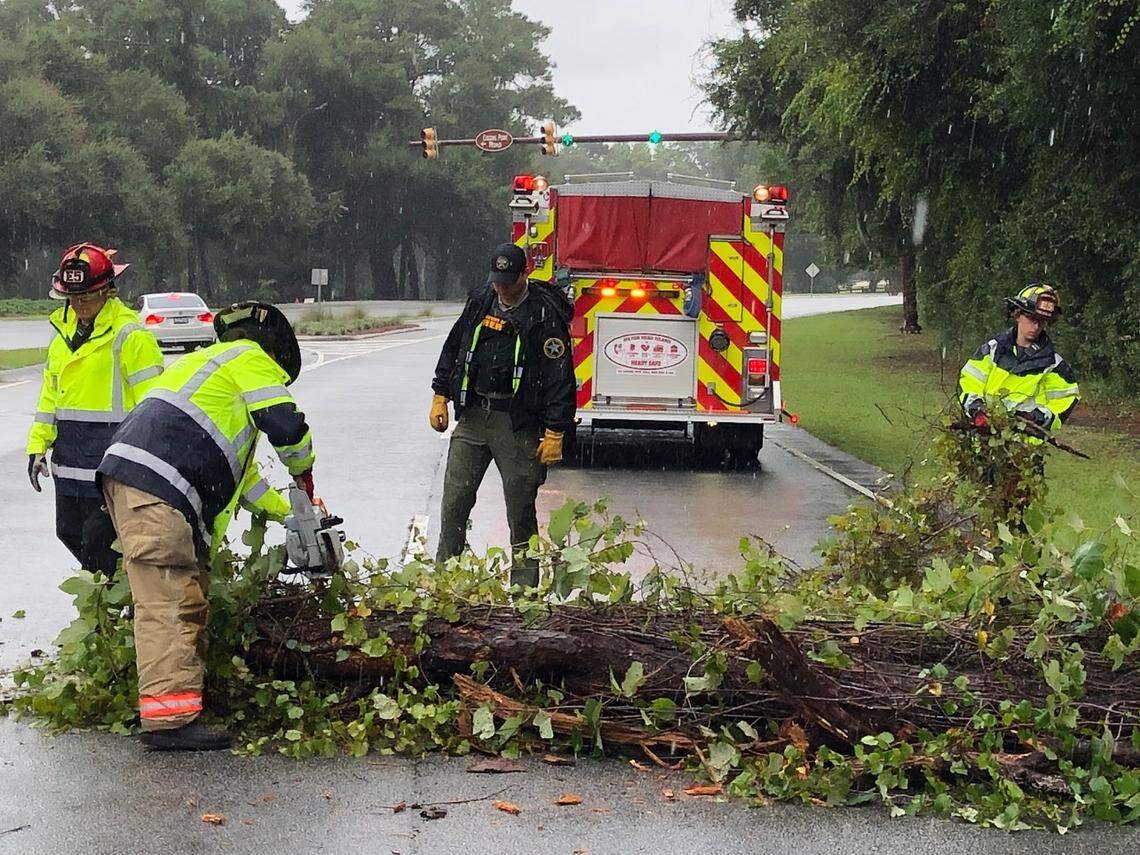 Hilton Head Island Fire and Rescue firefighters remove a downed tree near Port Royal blocking two lanes on US 278 on Wednesday, September 4, 2019.