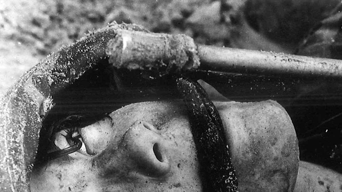 Marine recruit Beth Dailey from Platoon 4007 eyes the finish line at the Field Training Unit's Infiltration Course during Basic Warrior Training. Series 4006, the first female recruit series to participate in BWT, finished the program for enhancing combat skills on March 5, 1988.