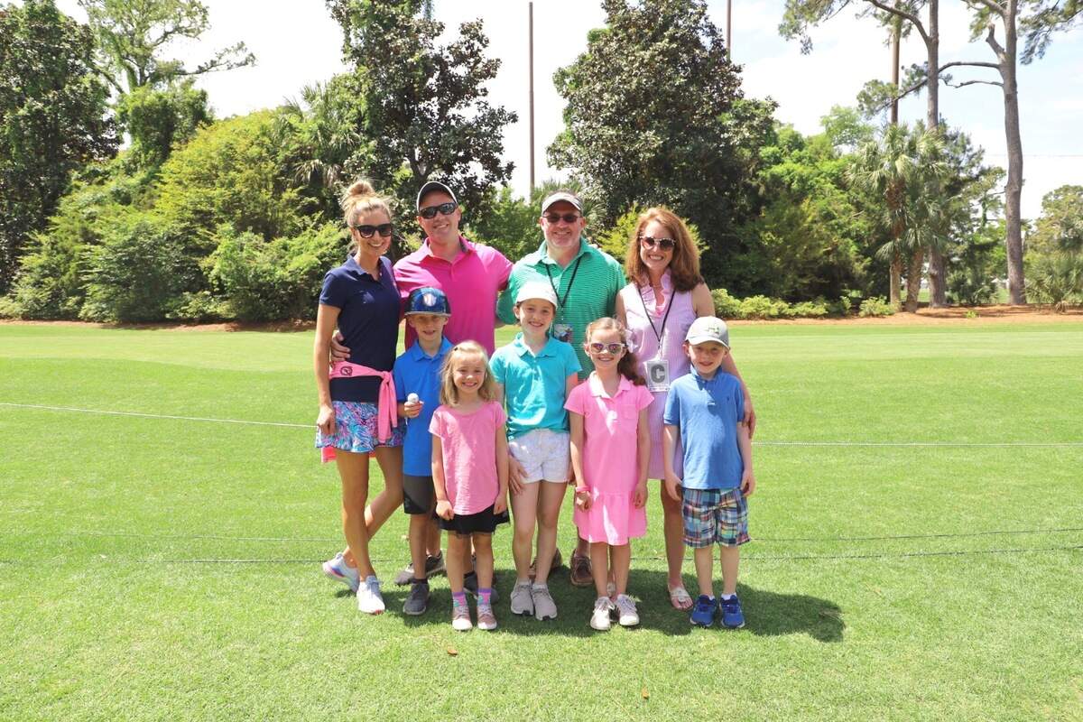 The Heinle and Brittingham families pose in their colorful, bright ensembles.