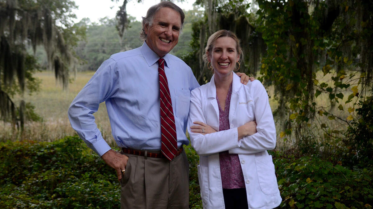 Dr. Gene Grace stands for a portrait with his daughter, Dr. Katherine Hefner, behind Aesthetic Dentistry, the Beaufort practice where they work together, on Nov. 9.