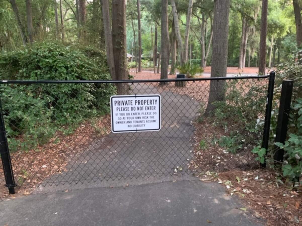 A fence blocking bike traffic near the entrance to Hilton Head Plantation on July 3, 2019. A property owners association near the pathway put up the fence to avoid liability since it empties into a parking lot.