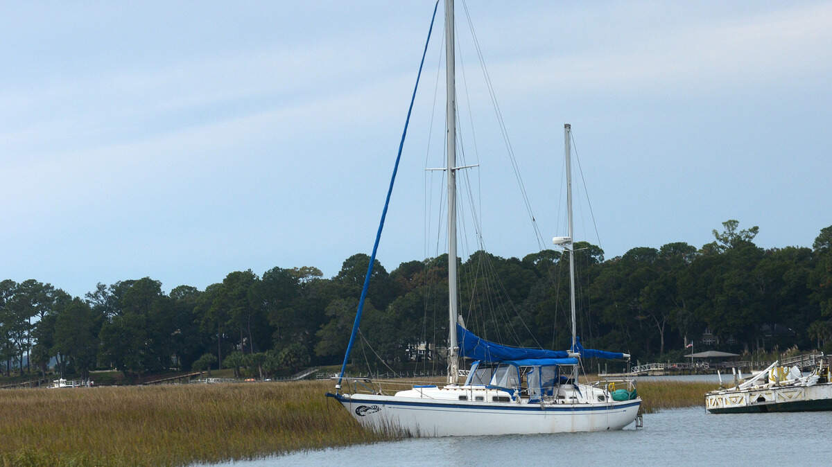 A boat that had begun to capsize at Palmetto Bay Marina was pushed into a nearby marsh so as not to jepordize the other boats docked at the marina on Hilton Head Island.