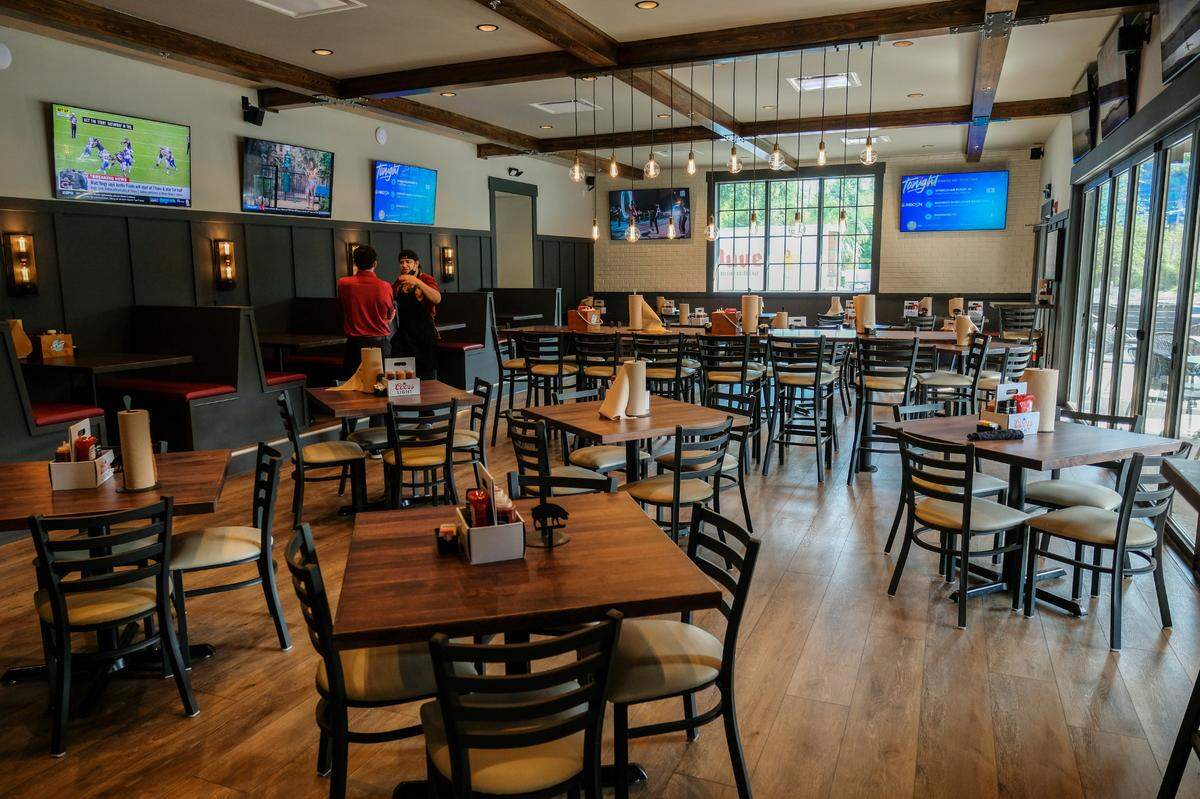 The dining room, with louvered doors recovered from the former building, at right, opens to outside patio seating as seen on Tuesday, Aug. 24, 2021, at The Smokehouse on Hilton Head Island.
