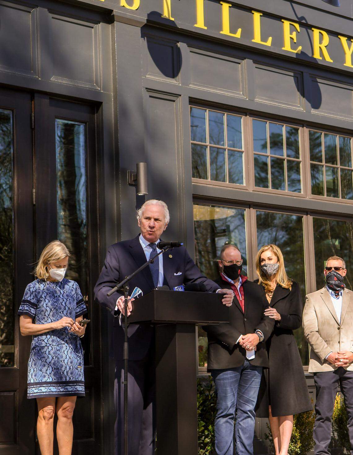 SC Gov. Henry McMaster speaks at the grand opening of Burnt Church Distillery on Friday, March 5, 2021 as, from left to right, Bluffton Mayor Lisa Sulka; co-owner Billy J. Watterson and his wife, Brenda Watterson; and co-owner Sean Watterson listen in Bluffton. Before McMaster spoke, Billy J. Watterson talked about the unfair obstacles the brothers face in operating their more than $10 million investment with limited hours and limited spirits that people can be served.