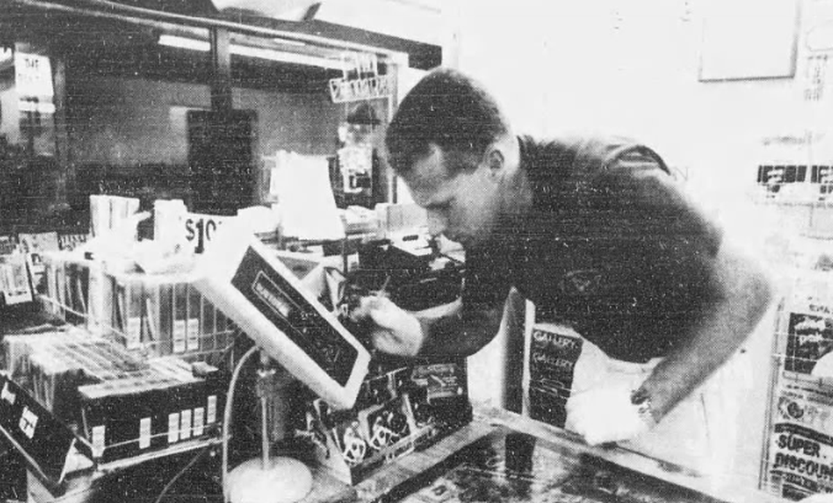 Bob Bromage, formerly a deputy with the Beaufort County Sheriff’s Office, dusts the cash register for fingerprints after a late-shift worker was fatally shot Aug. 3, 1994, inside The Pantry convenience store just west of the bridges to Hilton Head Island. The murder case remained unsolved in 2025, less than a year after the gas station’s roof caved in under the weight of a tropical storm deluge.