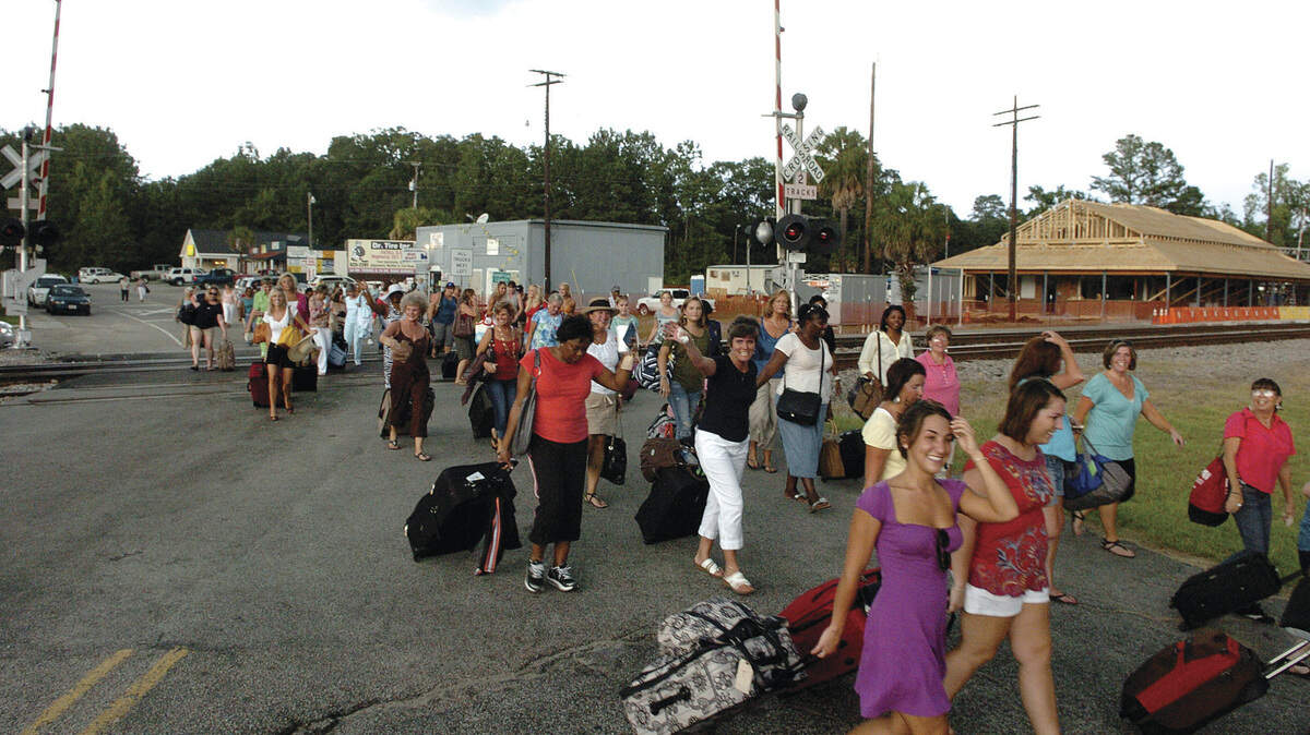 In this file photo taken in July, women residents of Yemassee practice leaving town during a rehearsal for the television show "The Week the Women Went." The five-day series, the first episode of which airs tonight on Lifetime, chronicles how the men and children of the town survived for seven days taking care of business while also completing a community project with the women away.