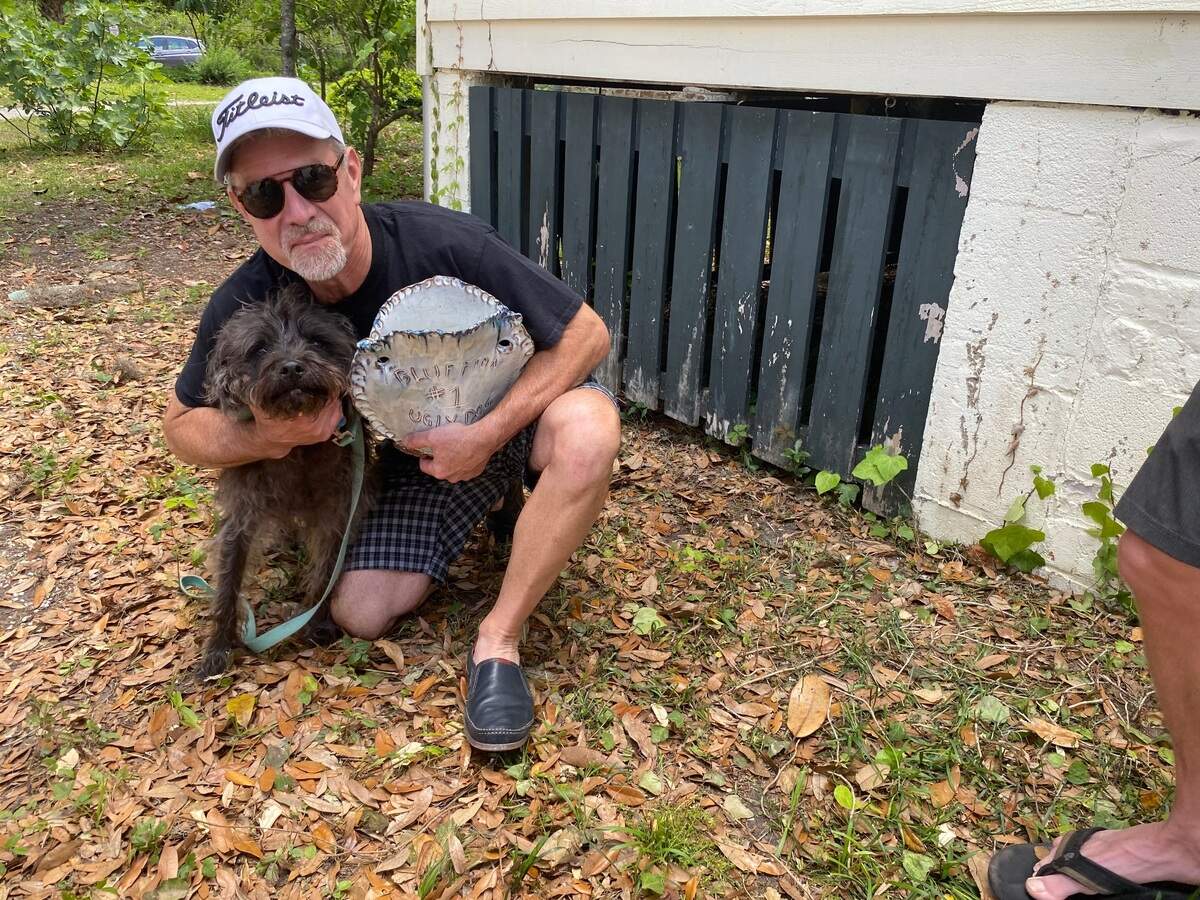 Steve Hale poses with winning pup Charlie and prized “trophy” after the Ugly Dog Contest at Bluffton Mayest on Saturday, May 7, 2022. It was Charlie’s fifth win.