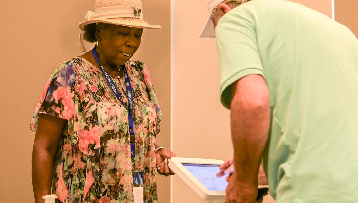 Anne Cooke, left, a Beaufort County Poll Clerk chats with a voter as they sign their name on Tuesday, June 14, 2022 to vote in the primary election at the Bluffton Library.