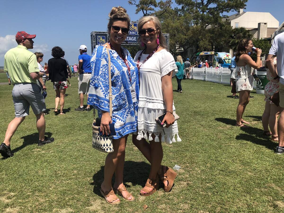 Katy Pennell, wearing the white flowy mini-dress, poses with her friend Samantha Gramke.