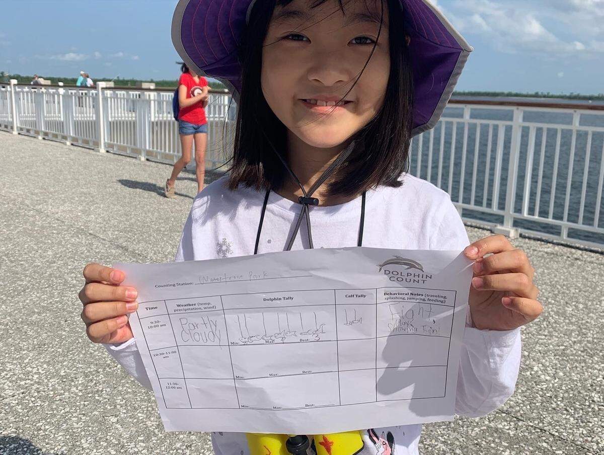 A young volunteer holds up a data sheet during the Lowcountry Marine Mammal Network’s dolphin count event in 2022. The data-collection happens once a year and brings in hundreds of volunteers to count dolphins around Charleston’s peninsula