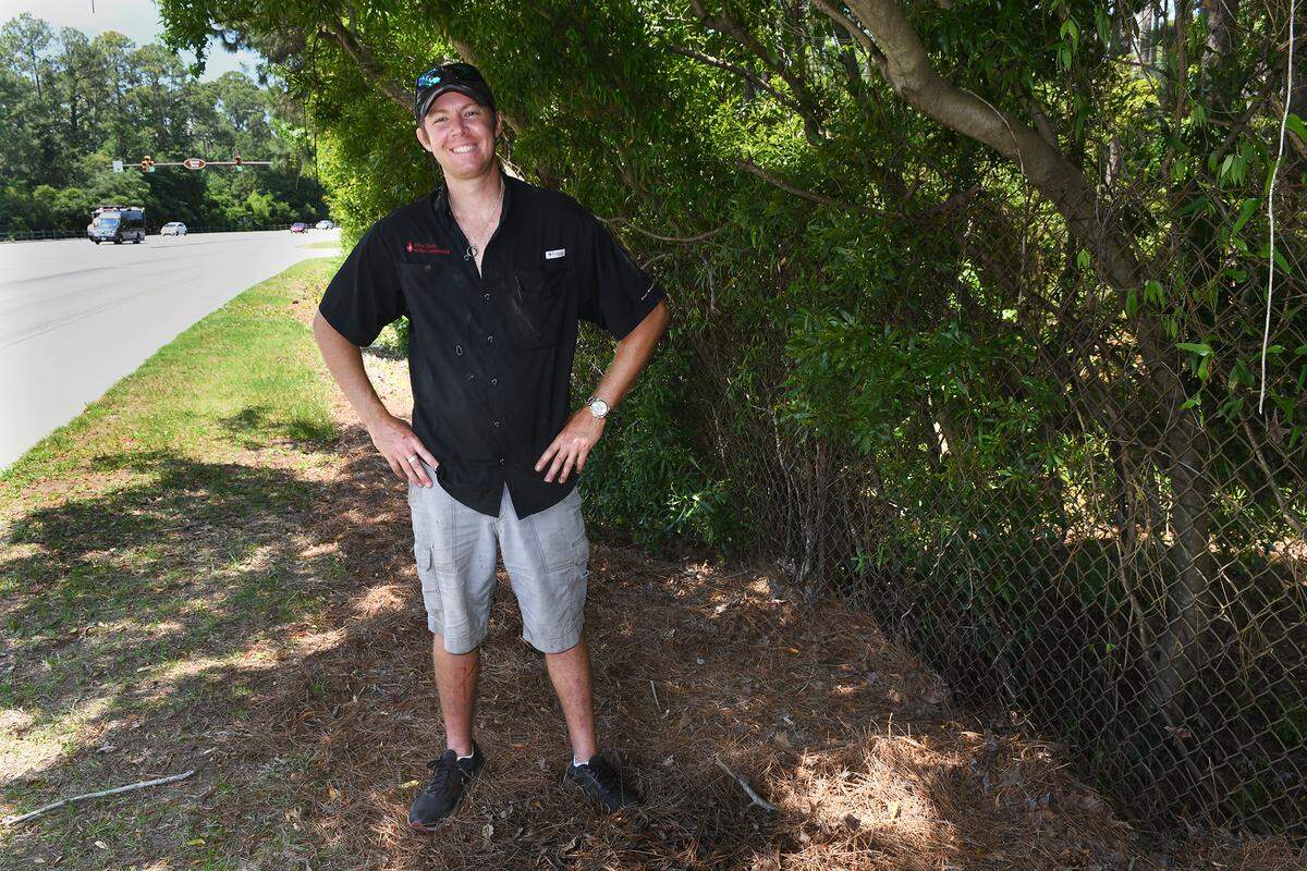 Logan Cambron is photographed on Wednesday near the site where he helped Hilton Head Island Fire and Rescue Division capture an alligator that had gone on walkabout and was pushing against a fence on the shoulder of Palmetto Bay Road near the corner of Arrow Road. The large reptile was causing a traffic hazard as curious motorists slowed to look at it. After the capture, Cambron was entrusted to release the creature in a nearby pond where it was still swimming about as of Wednesday afternoon.