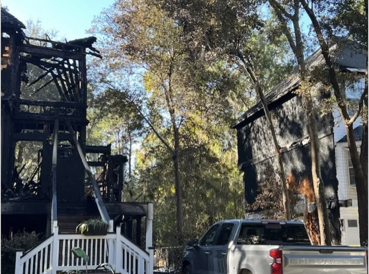 Flames from a fatal Tuesday night house fire charred the edges of neighboring houses on Victoria Square Drive.