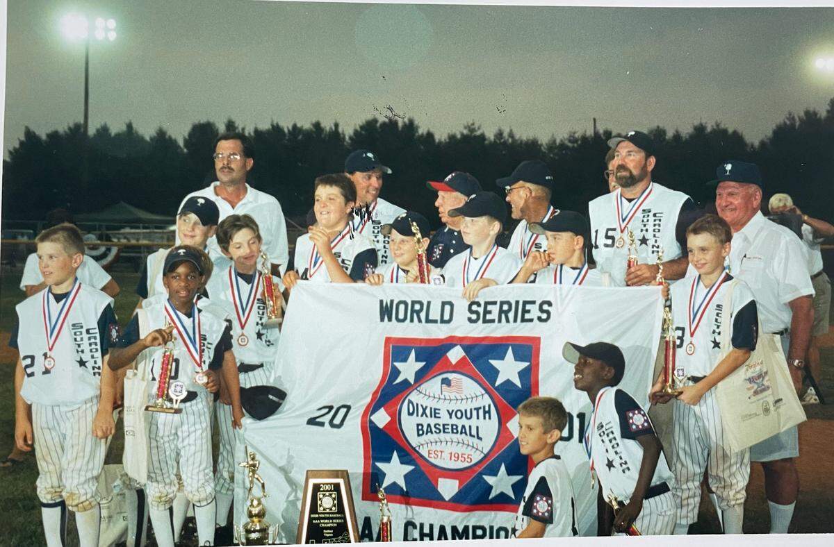 Team with banner and trophies after World Series win